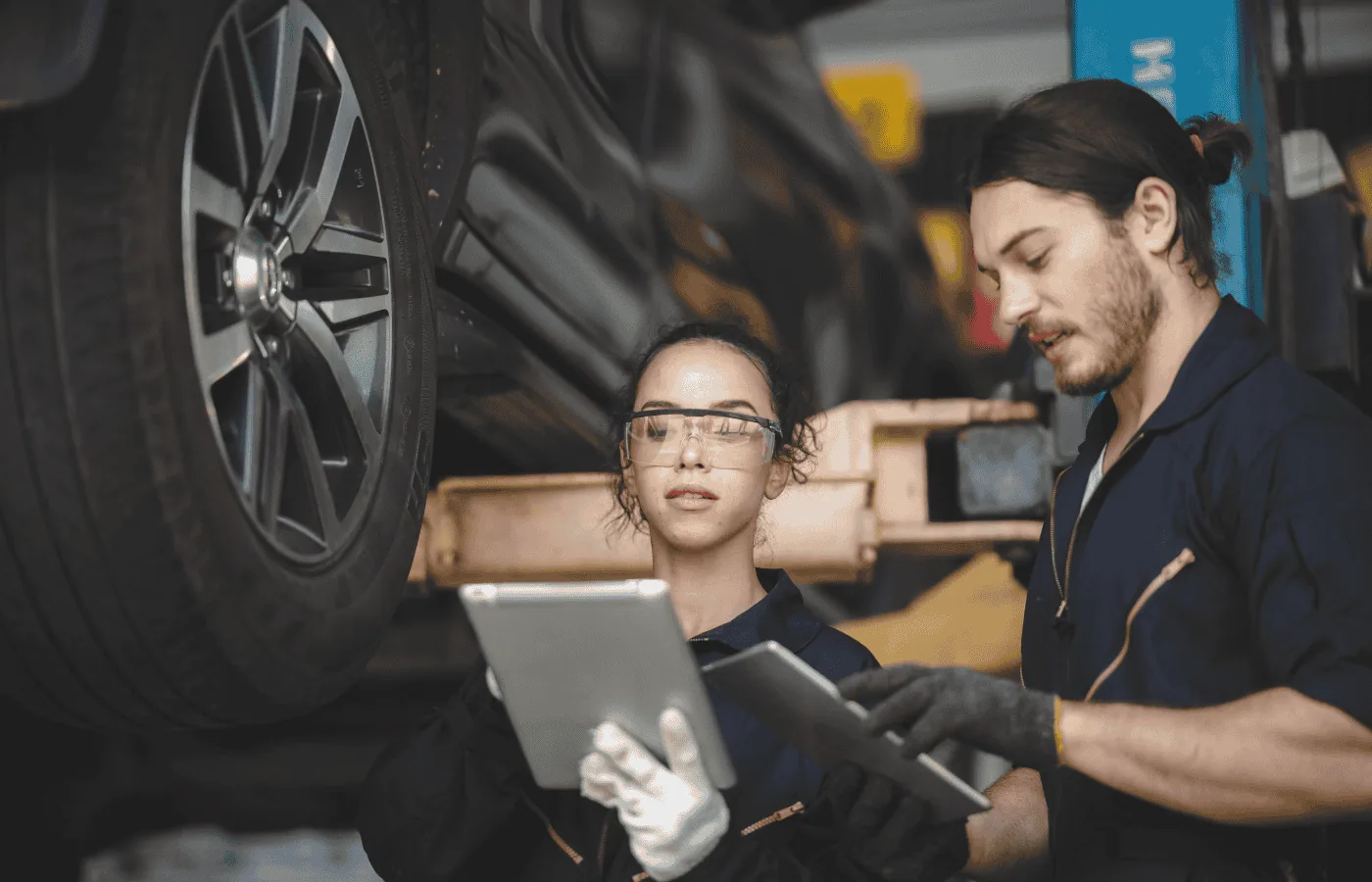 Mechanic reviewing repair on tablet