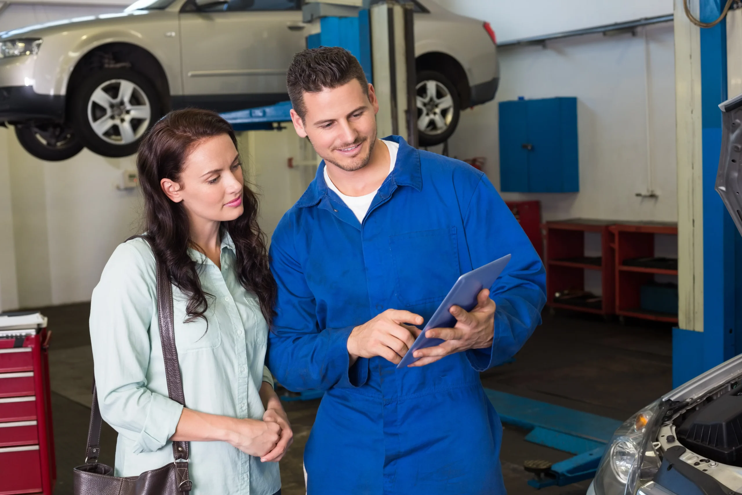 Repair shop team reviewing work with a customer